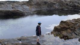 Josh checks out the enormous rock pool at Treyarnon Bay
